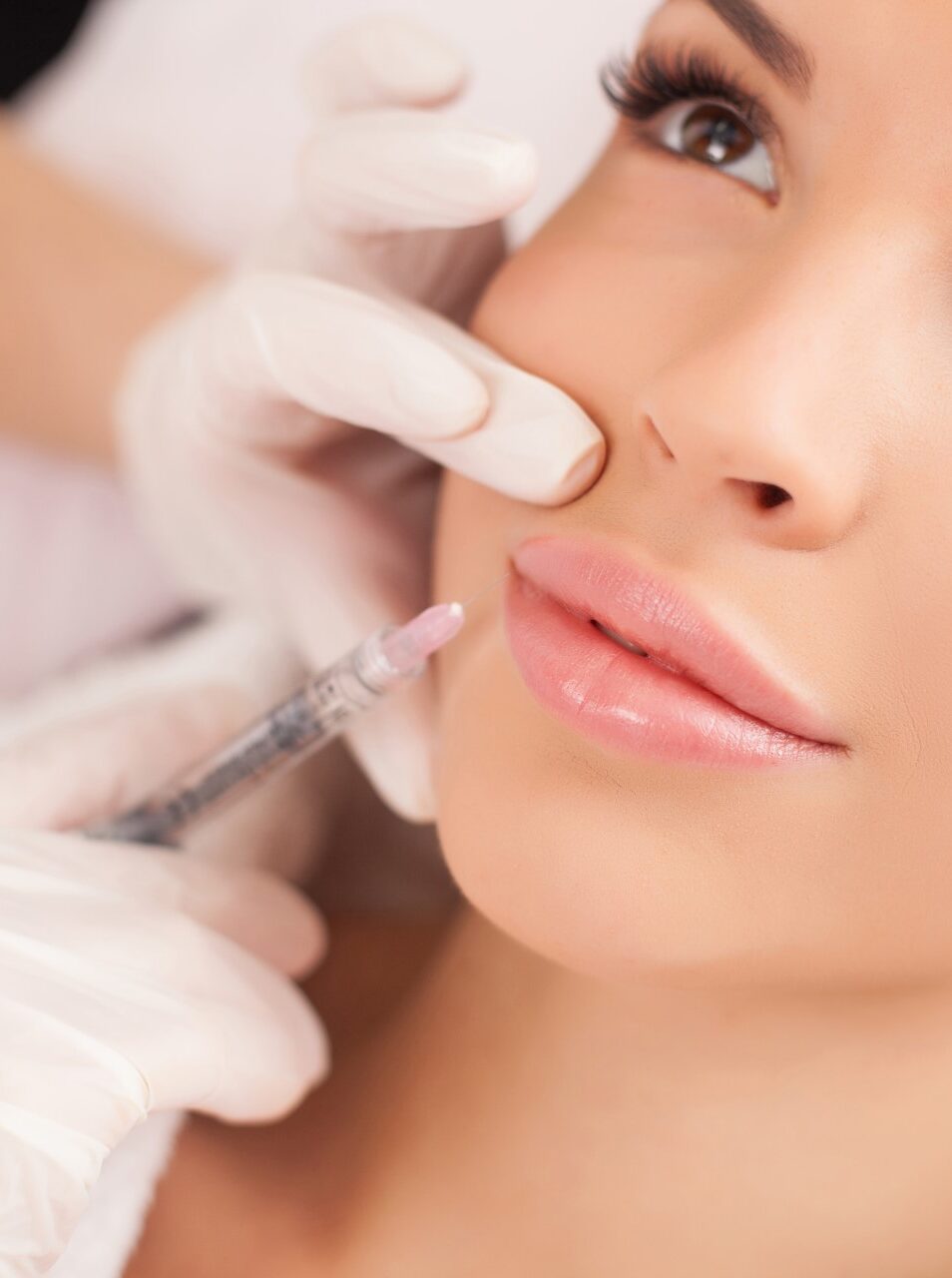 Close up of hands giving a dermal filler injection.