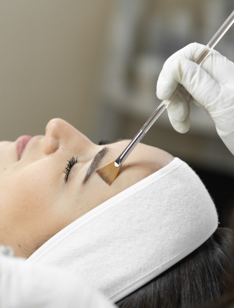 Young woman receiving chemical peel.